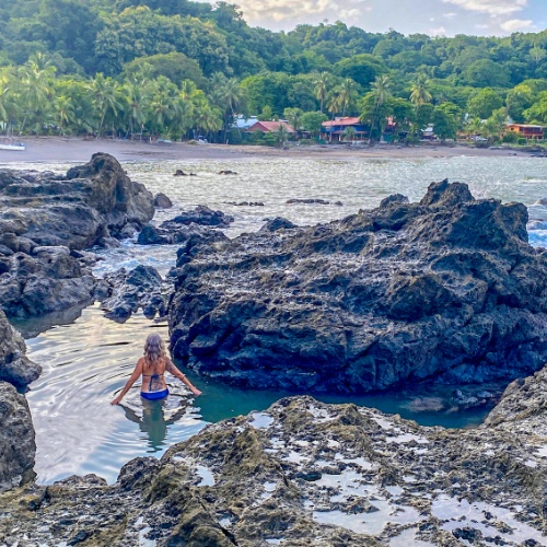 Woman wading in the Pico tide pool, Montezuma Costa Rica
